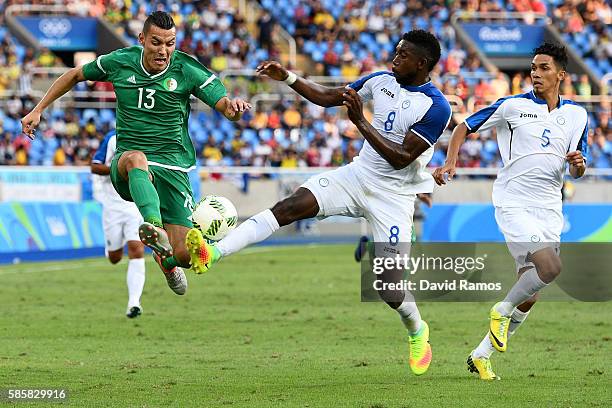 Ben Tahar Meziane of Algeria battles for the ball with Johnny Palacios of Honduras during the Men's Group D first round match between Honduras and...