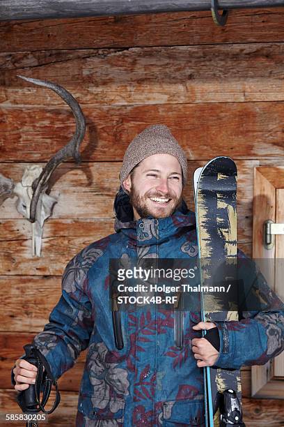 man in winter clothing at wooden hut, spitzing, bavaria, germany - bayern winter stock-fotos und bilder