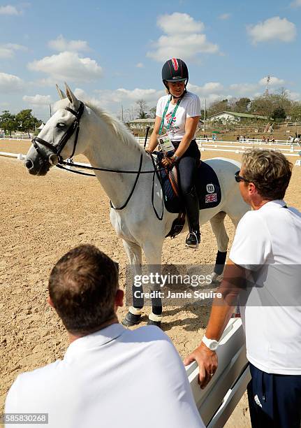 Pippa Funnell of Great Britain abord Billy The Biz talks with team members Carl Hester and Spencer Wilton during an Equestrian training session ahead...