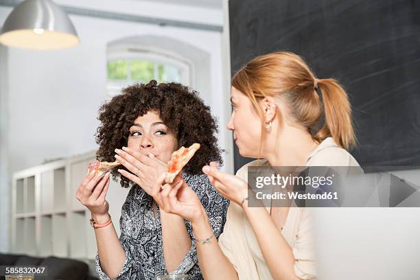 two colleagues in office eating pizza - coworker lunch stock pictures, royalty-free photos & images