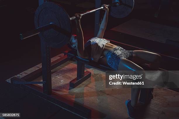 female athlete doing bench presses with barbell - bench press stock pictures, royalty-free photos & images