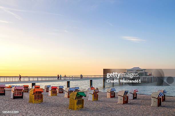 germany, niendorf, view to timmendorfer strand with hooded beach chairs and sea bridge - timmendorfer strand stock-fotos und bilder