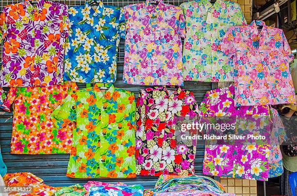 colorful shirts on the street during the songkran festival bangkok - songkran festival stock-fotos und bilder