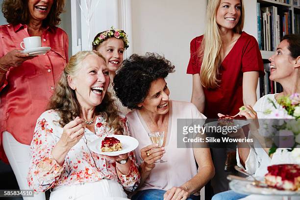 portrait of a joyful group at a party eating cake and having fun - senior birthday stock pictures, royalty-free photos & images