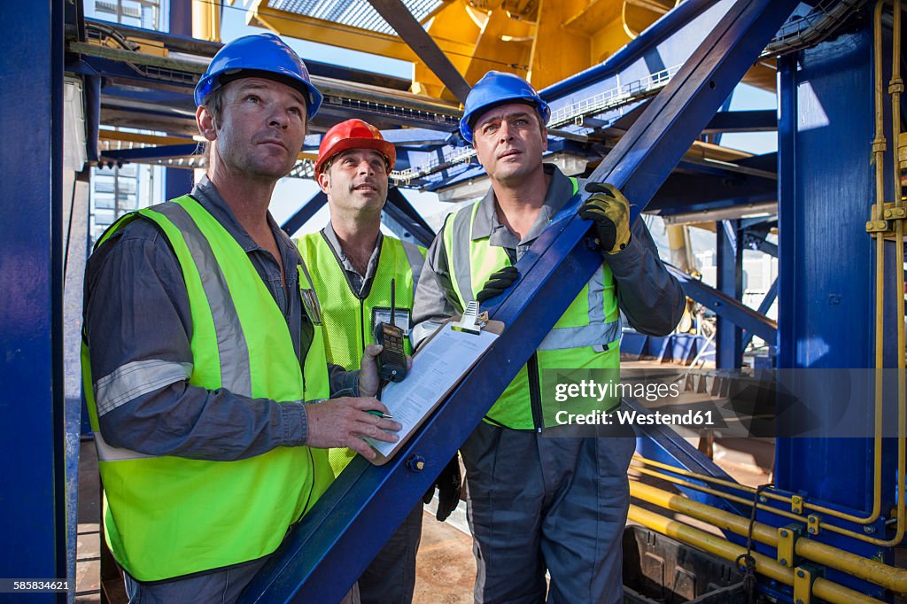 Crew onboard a ship inspecting with clipboard