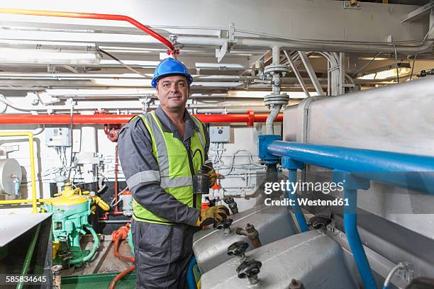 portrait of a mechanic in engine room on a ship - ship crew stock pictures, royalty-free photos & images