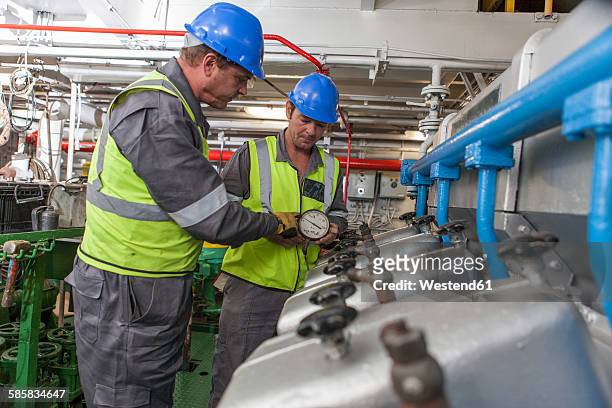 crew working in engine room on a ship - エンジンルーム ストックフォトと画像