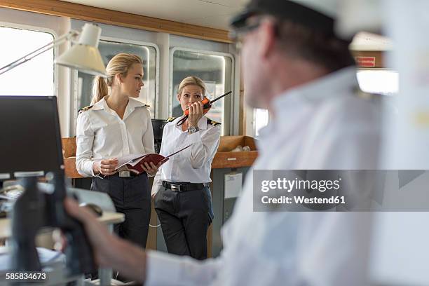 deck officers and ship captain on bridge - kapitän uniform stock-fotos und bilder