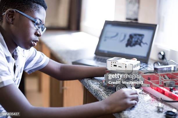 schoolboy with laptop in robotics class - africa school stock pictures, royalty-free photos & images