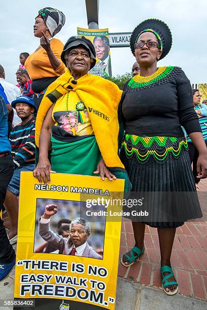 Vilakazi Street, Soweto, South Africa: South Africans react to the passing of Nelson Mandela, singing freedom songs and brandishing memorabilia of...