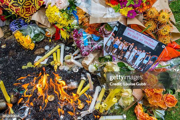 South Africans gather to pay tribute to Nelson Mandela outside his Johannesburg home Friday morning after he passed away Thursday night.