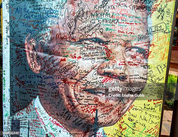 Vilakazi Street, Soweto, South Africa: A [oster of Nelson Mandela, outside his home in Vilakazi Street, Soweto, bears messages from well-wishers from...