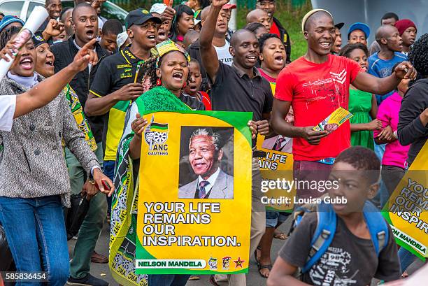 Vilakazi Street, Soweto, South Africa: South Africans react to the passing of Nelson Mandela, singing freedom songs and brandishing memorabilia of...