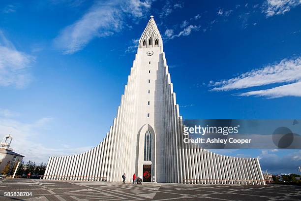 the iconic hallgrims kirkja in reykjavik, icelands largest church, designed by gudjon samuelsson, to resemble columnar jointing in basalt lava flows. - reykjavik stock pictures, royalty-free photos & images