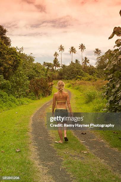 young girl walking down path in tropical location - cook islands stock pictures, royalty-free photos & images