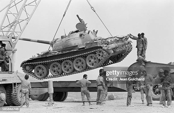 Tank captured from Iraqi forces during the 1980 Iran-Iraq War is requisitioned by members of the Iranian army.