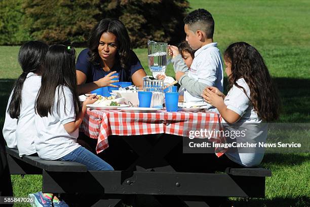 The White House- Washington DC First Lady Michelle Obama harvests the White House vegetable garden with the help of local grade school children. The...