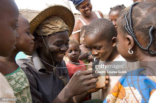 Farmer and bicycle fitter Nuru Ziblim teaches children how to filter their water with a special drinking device, when visiting the farms, so as to...