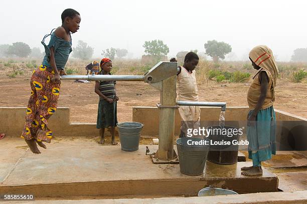Children collect daily family water needs from new boreholes, which supply filtered water free of guinea worm larvae.