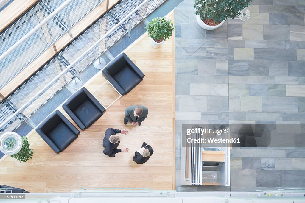 Three business people communicating