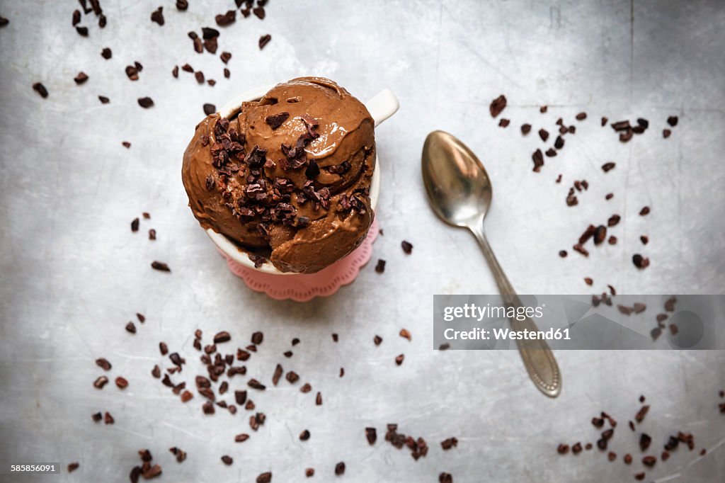 Cup of vegan chocolate banana ice cream decorated with cacao nibs