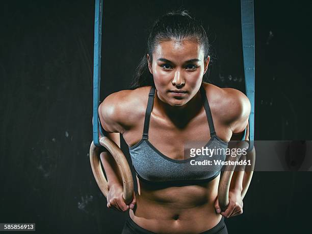 portrait of gym athlete with gymnastic rings - gymnastic asian stockfoto's en -beelden