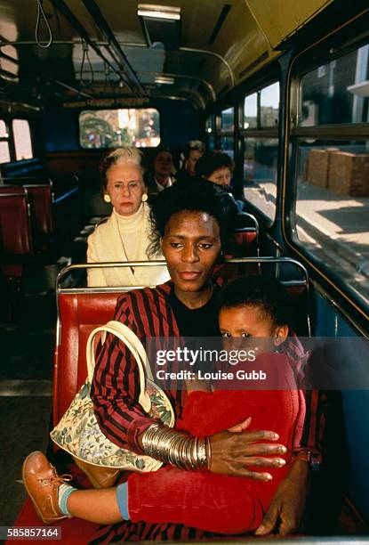 With the relaxing of Apartheid laws, blacks can ride on white buses in South Africa.