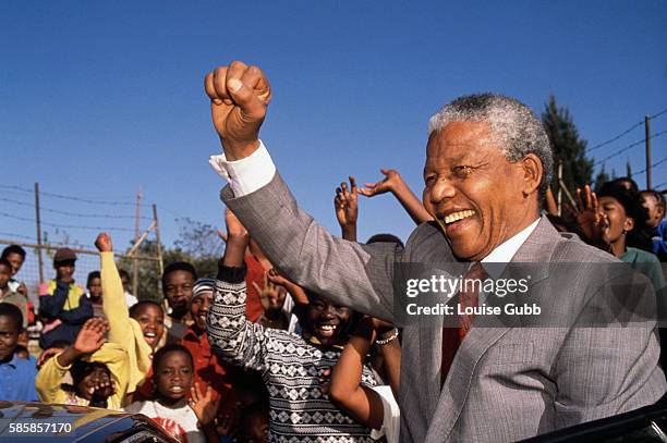 Johannesburg, South Africa: Nelson Mandela visits Hlengiwe School to encourage students to learn - Former President of South Africa and longtime...