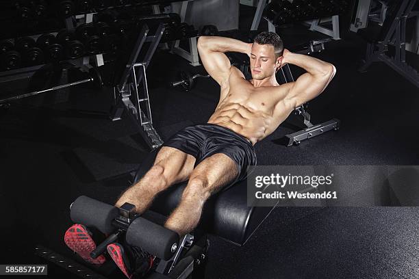 physical athlete exercising with glute ham developer - muscolo addominale foto e immagini stock