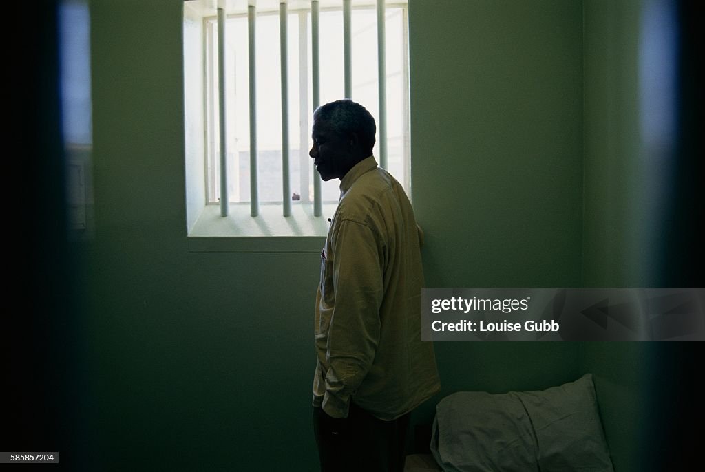 Nelson Mandela Stands At The Window Of The Cell In Robben Island nelson-mandela-stands-at-the-window-of-the-cell-in-robben-island
