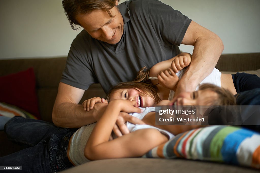 Father playing with his children at home