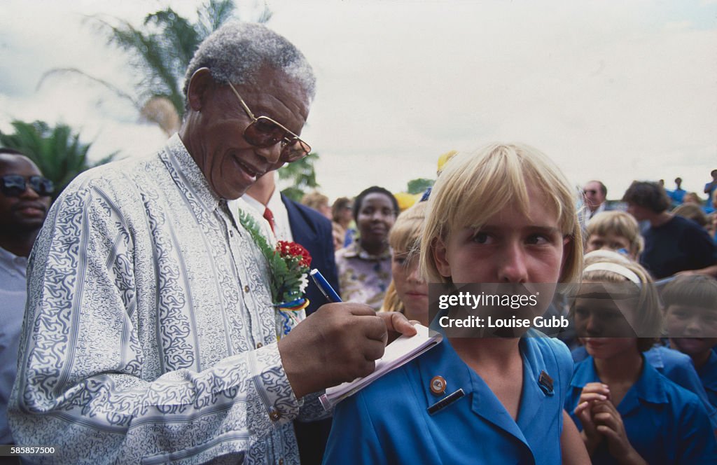 Nelson Mandela Signing His Autograph for Young Admirer