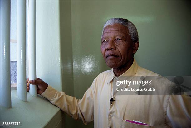Nelson Mandela stands at the window of the cell in Robben Island Prison where he was incarcerated for more than two decades. He was held as a...