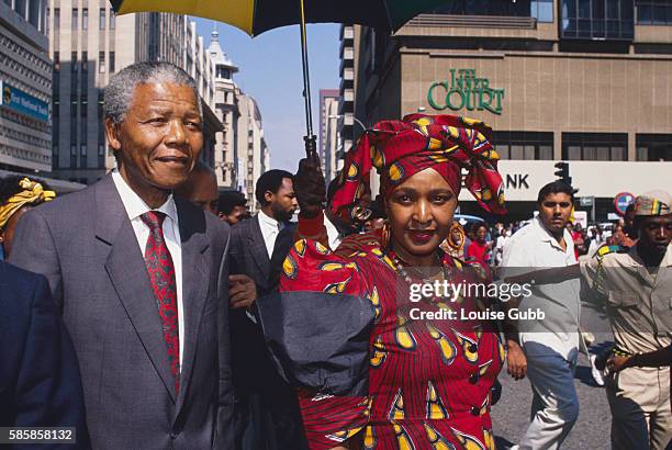 Nelson Mandela escorts his wife Winnie to court during her trial for kidnapping and assault of children. Former President of South Africa and...