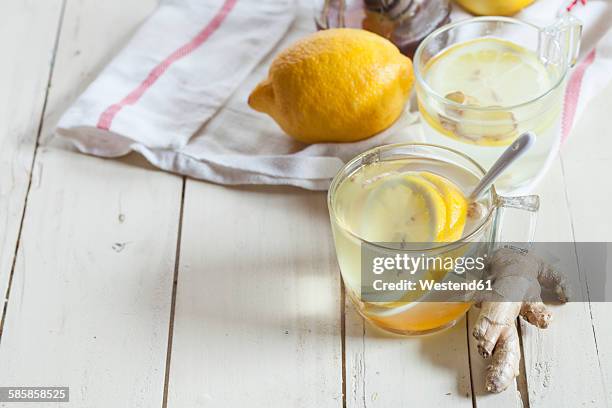 hot lemon-ginger infusion with honey - ginger glasses stock-fotos und bilder