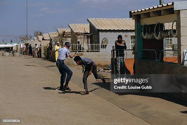Black township resident is beaten by a white policeman near witnesses on a street in South Africa. With the coming of a freer political climate,...