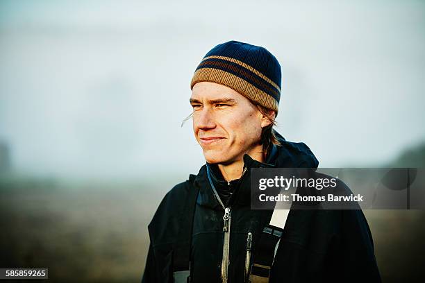 organic farmer standing in field at sunrise - winter hat stock pictures, royalty-free photos & images