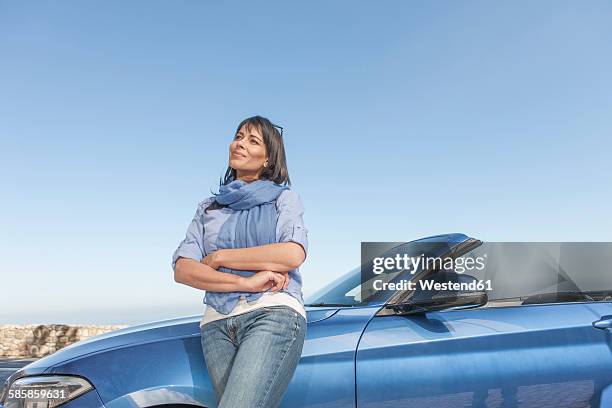 south africa, woman standing next to a convertible - toyota south africa motors stock pictures, royalty-free photos & images