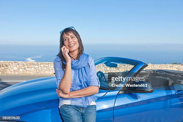 south africa, woman next to a convertible on the phone - toyota south africa motors stock pictures, royalty-free photos & images