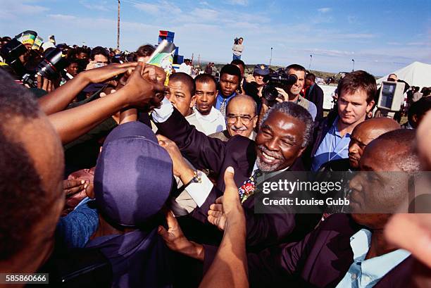 South African presidential candidate Thabo Mbeki shacks hands supporters at the opening of a public water project in Peddie, South Africa just before...
