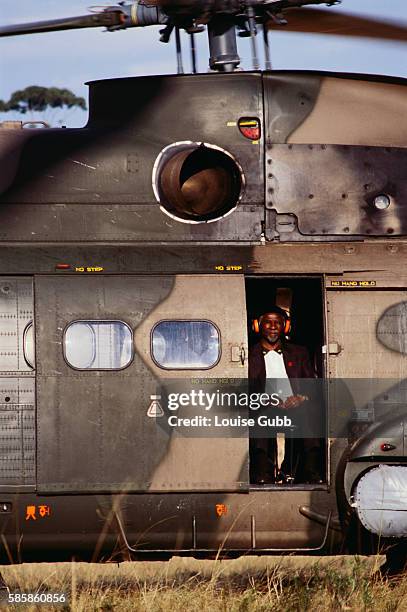 Presidential candidate Thabo Mbeki sits in a military helicopter while campaigning in rural South Africa. | Location: Kucentane, South Africa.