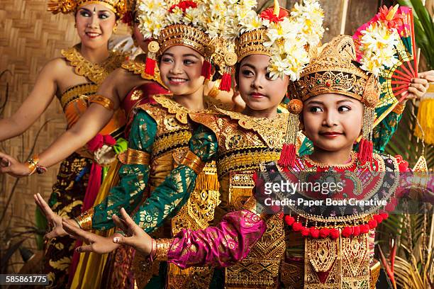 row of traditional balinese dancers in costume - indonesia stock pictures, royalty-free photos & images