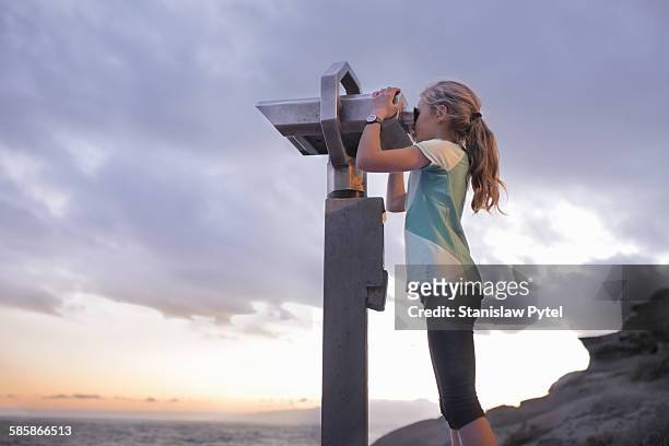 girl looking through telescope, ocean and clouds - watching sunset stock pictures, royalty-free photos & images