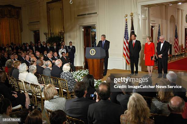 President George W. Bush, center, speaks before swearing in John Roberts as the 17th chief justice of the United States during a ceremony in the East...