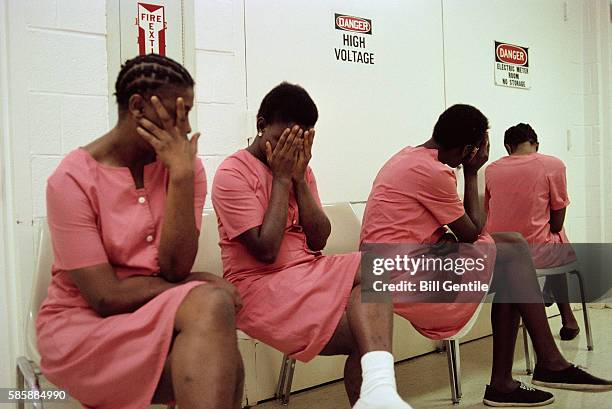 female inmates hiding their faces - black person prison stock pictures, royalty-free photos & images