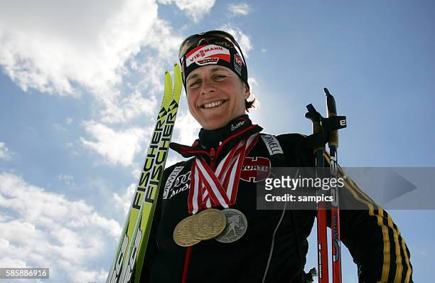 Uschi Disl shows off her medals at the 2005 Biathlon World Championship in Hochfilzen, Austria. March 6, 2005.