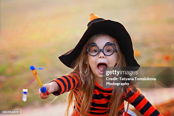 girl dressed for halloween - witch wand stock pictures, royalty-free photos & images