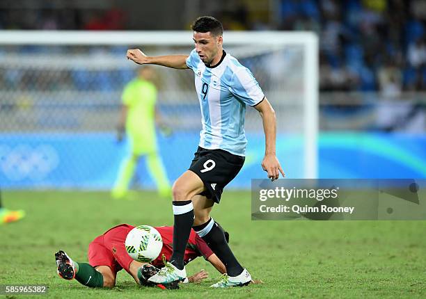 Jonathan Calleri of Argentina is tackled during the Men's Group D first round match between Portugal and Argentina during the Rio 2016 Olympic Games...