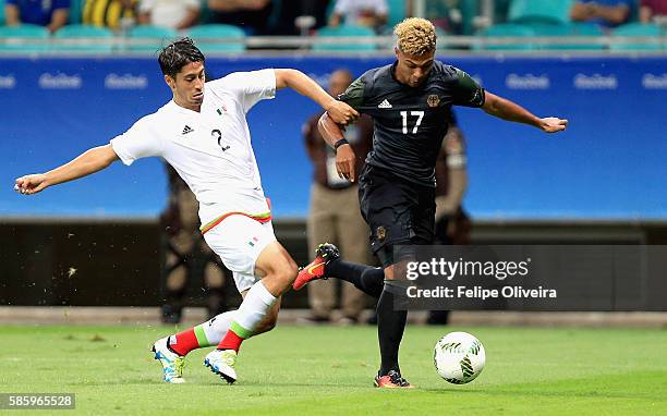 Serge Gnabry of Germany is challenged by Jose Abella of Mexico during the Men's Group C first round match between Mexico and Germany during the Rio...