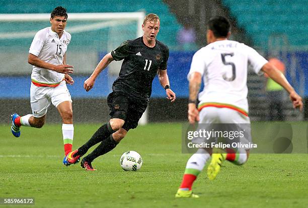 Julian Brandt of Germany is chased by Michael Perez of Mexico during the Men's Group C first round match between Mexico and Germany during the Rio...